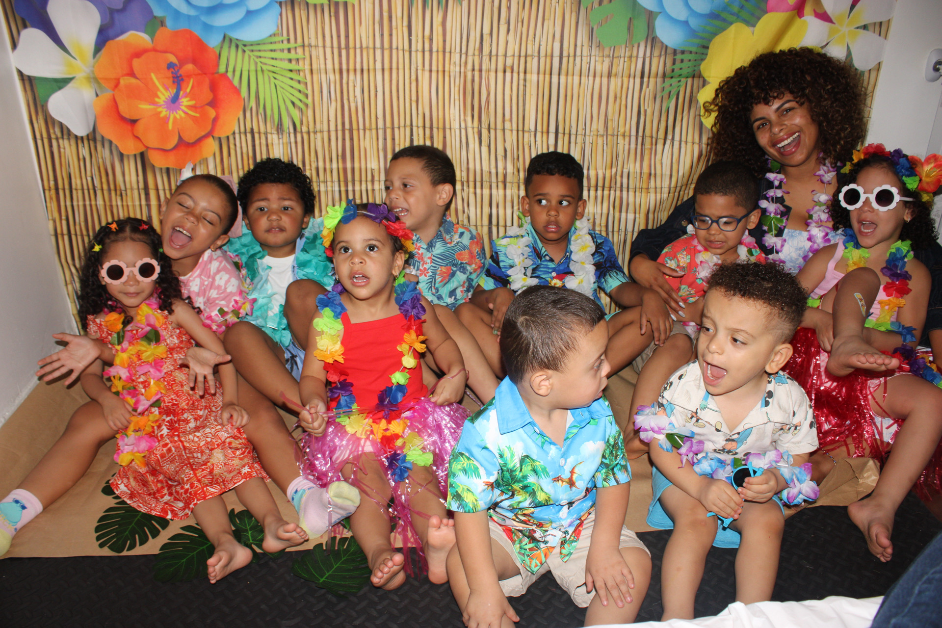 Children and a caregiver celebrating together at Learning Cube